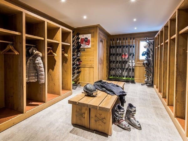 large wood mudroom with snow sports equipment