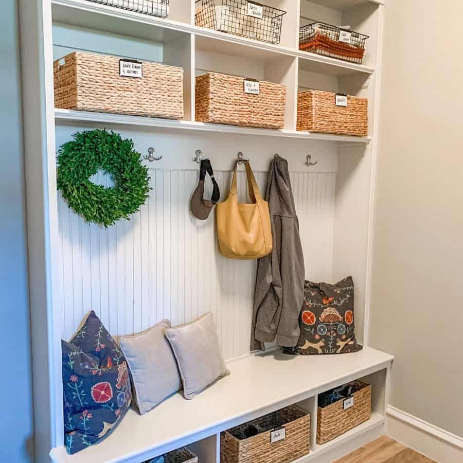 modern white mudroom with weaved basket storage