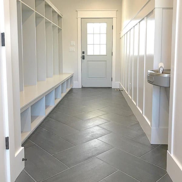 gray tiles in white cabinet mudroom