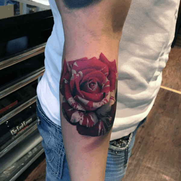 Close-up of a rose tattoo on a forearm