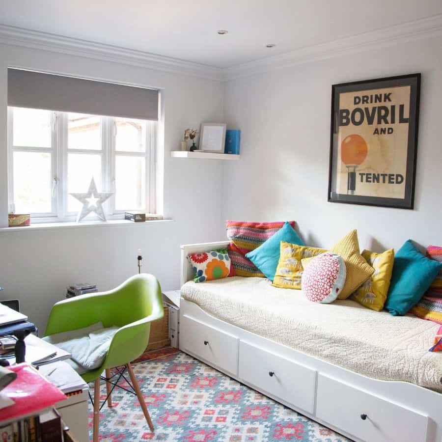 daybed with colorful pillows in small office green accent chair