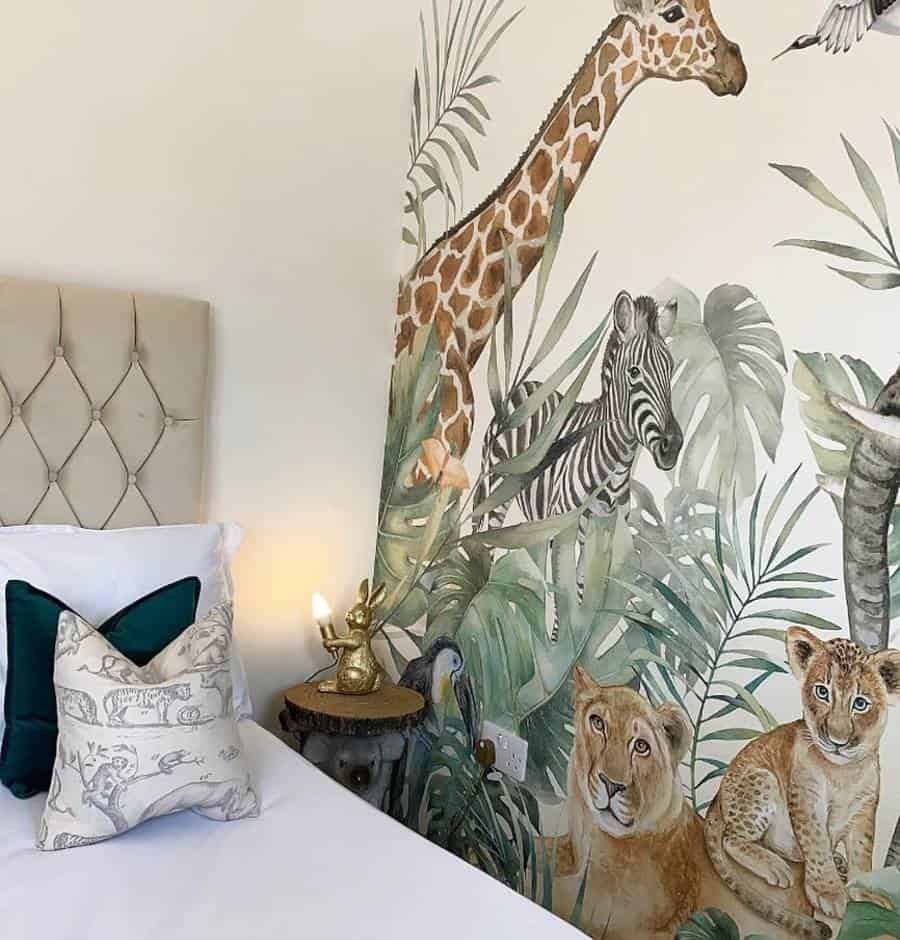 Safari-themed bedroom with an accent wall mural of a giraffe, zebra, and lions above a bed with decorative pillows