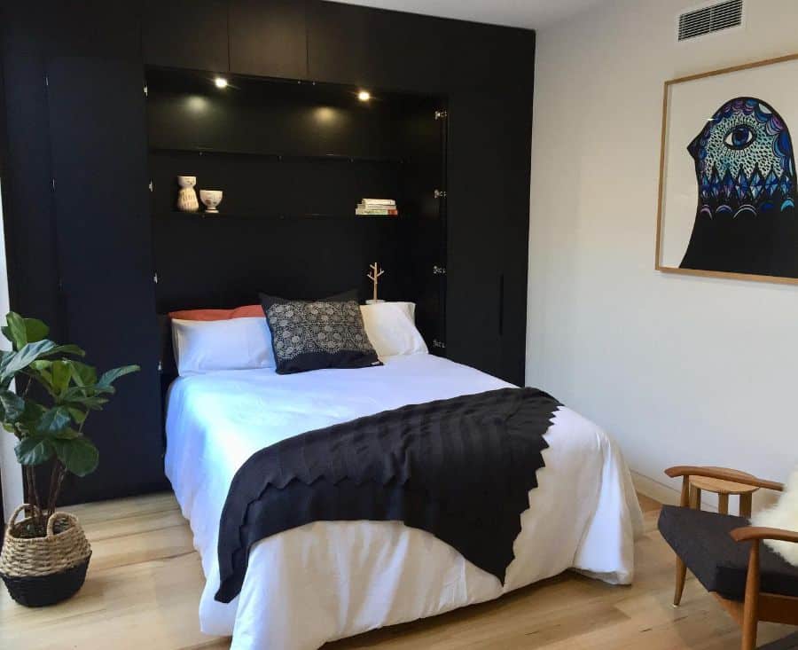 built-in murphy bed black feature wall bird artwork accent chair