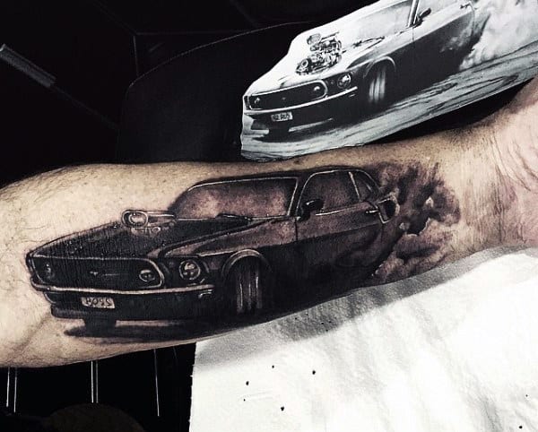 Tattoo on an arm depicts a sleek, vintage car with smoke trailing behind it