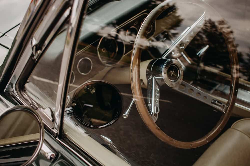 shot of a mustang interior, seen through a window, focused on the steering wheel