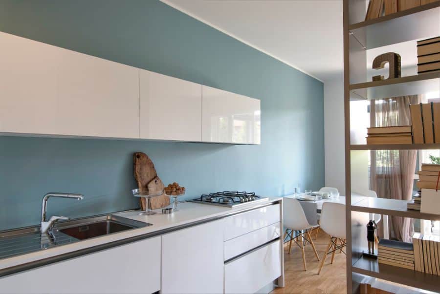 blue accent wall white cabinet kitchen bookshelf