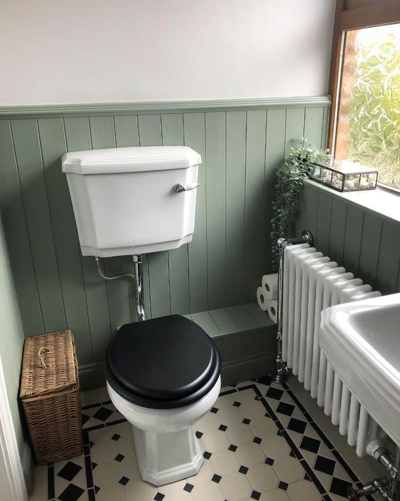 two tone color bathroom with white and green shiplap walls 