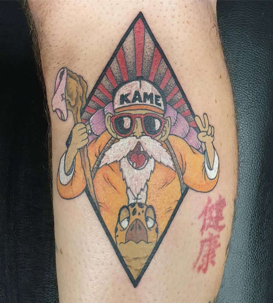 A tattoo of Master Roshi from Dragon Ball wearing sunglasses and holding a staff, with a turtle at his feet and a red sunburst in the background.