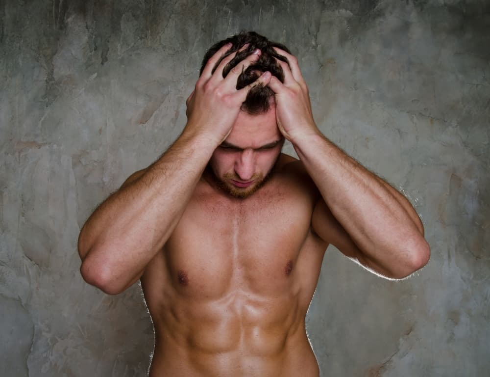 naked man standing while thinking of his problem