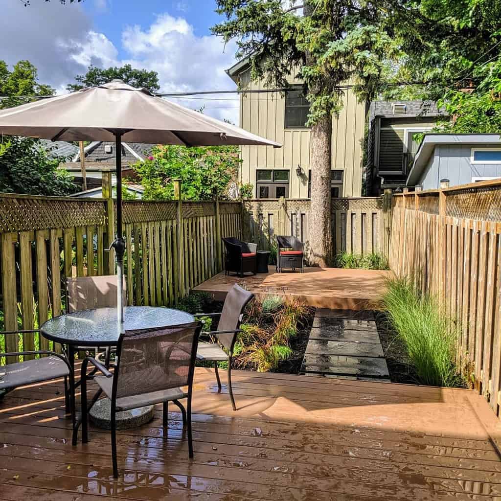 small narrow backyard with decks and outdoor furniture