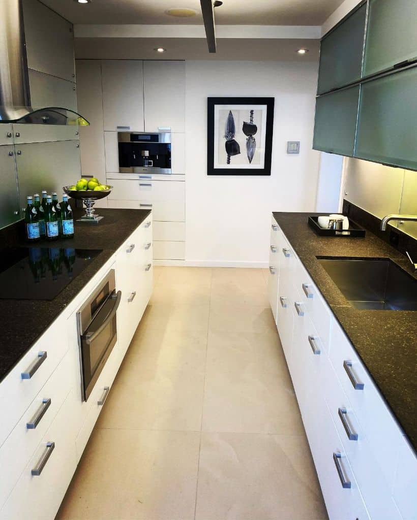 modern galley kitchen white cabinets black countertop