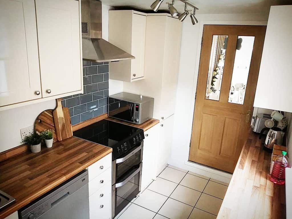 narrow country style galley kitchen white floor tiles