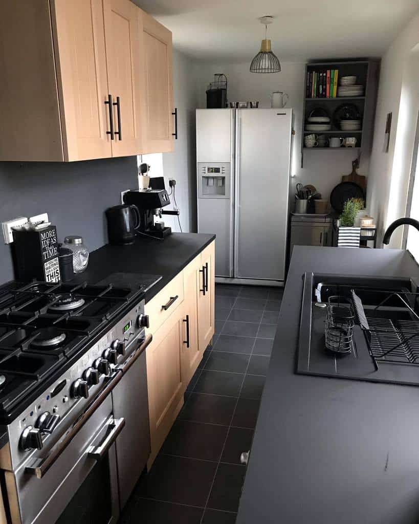 modern narrow galley kitchen wood cabinets black countertops