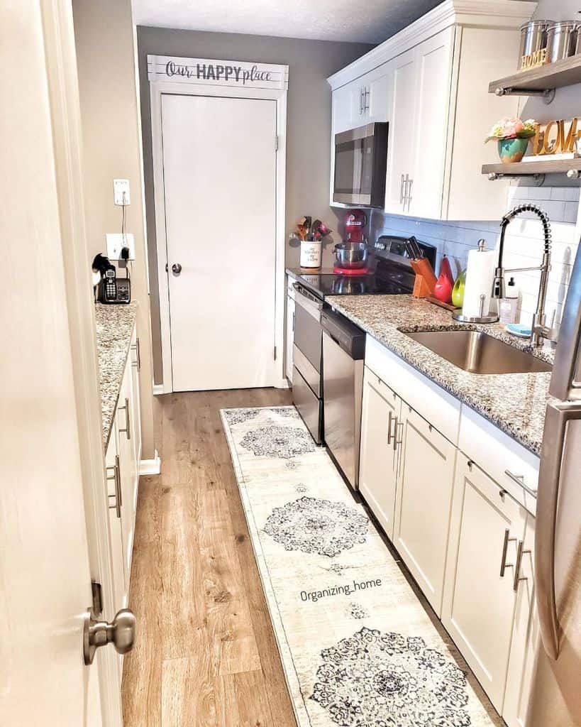 small narrow galley kitchen white cabinets white door