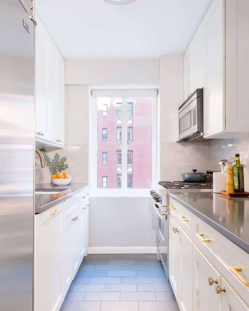 small narrow apartment galley kitchen white cabinets gold accents