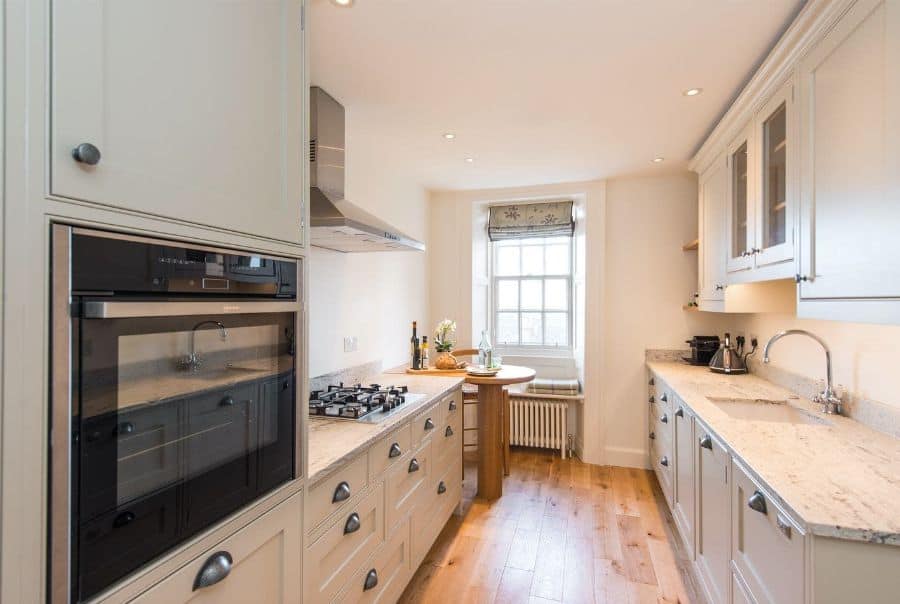 narrow white cabinet kitchenette wood floors
