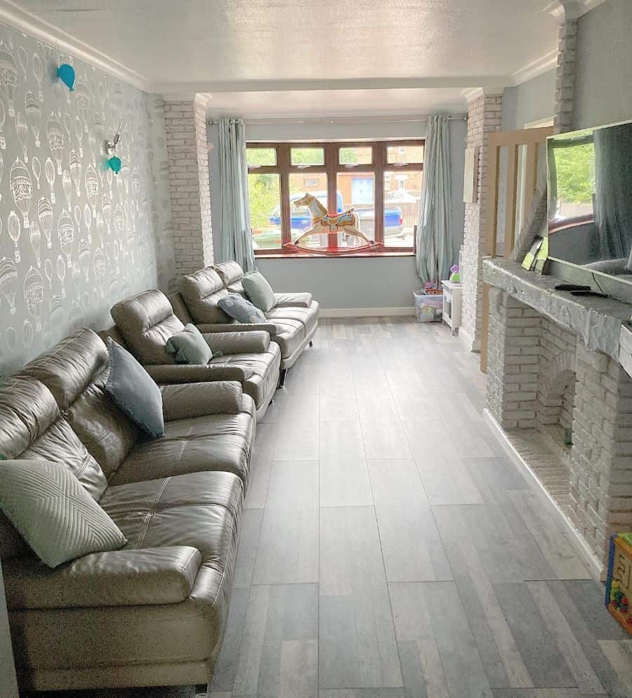 small living room with brick fireplace and leather sofas