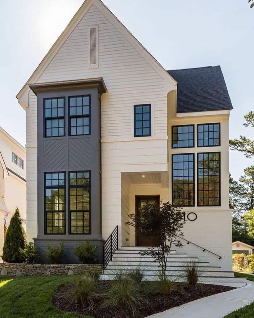 narrow double story farmhouse style home with gray and white exterior