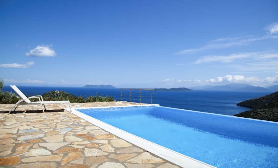 stone paver infinity pool deck with ocean view