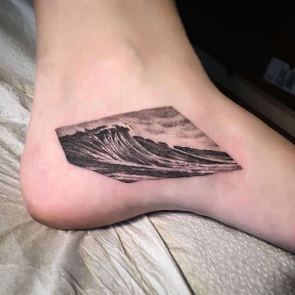 Realistic ocean wave tattoo, featuring detailed shading and a geometric frame for a bold yet natural design
