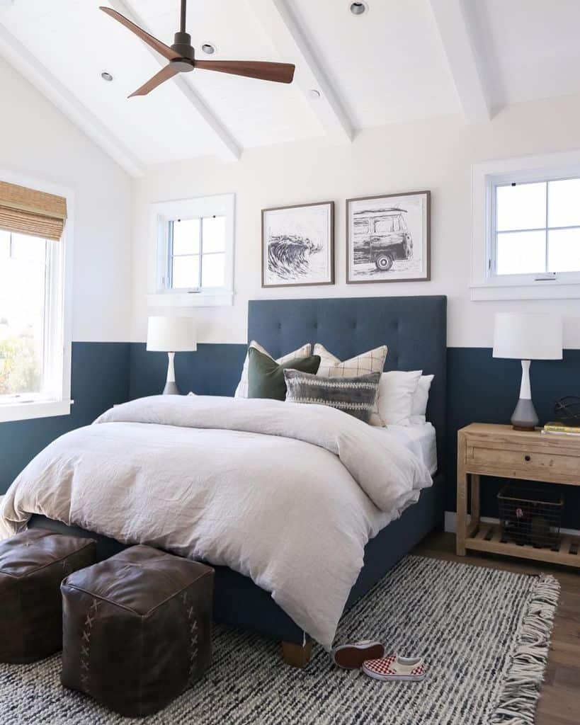 Navy blue and white bedroom with a cozy bed and rustic accents.