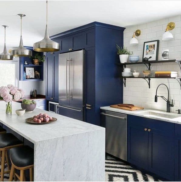 navy blue kitchen cabinets with wall shelves and marble island 