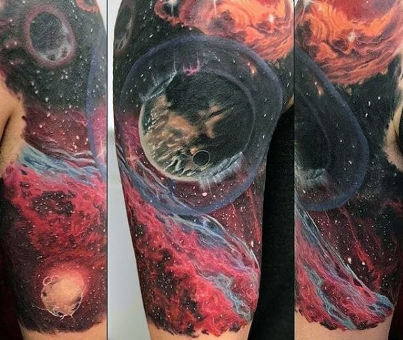 A colorful nebula tattoo featuring planets and cosmic elements wraps around an arm