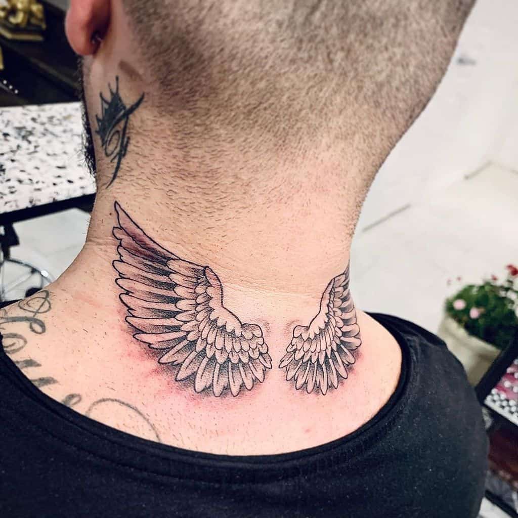 Detailed angel wings tattoo, with a soft gradient shading effect, symbolizing freedom and spiritual protection