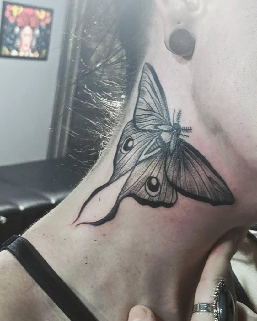 A black and grey tattoo of a Luna Moth, featuring detailed wing patterns and shading