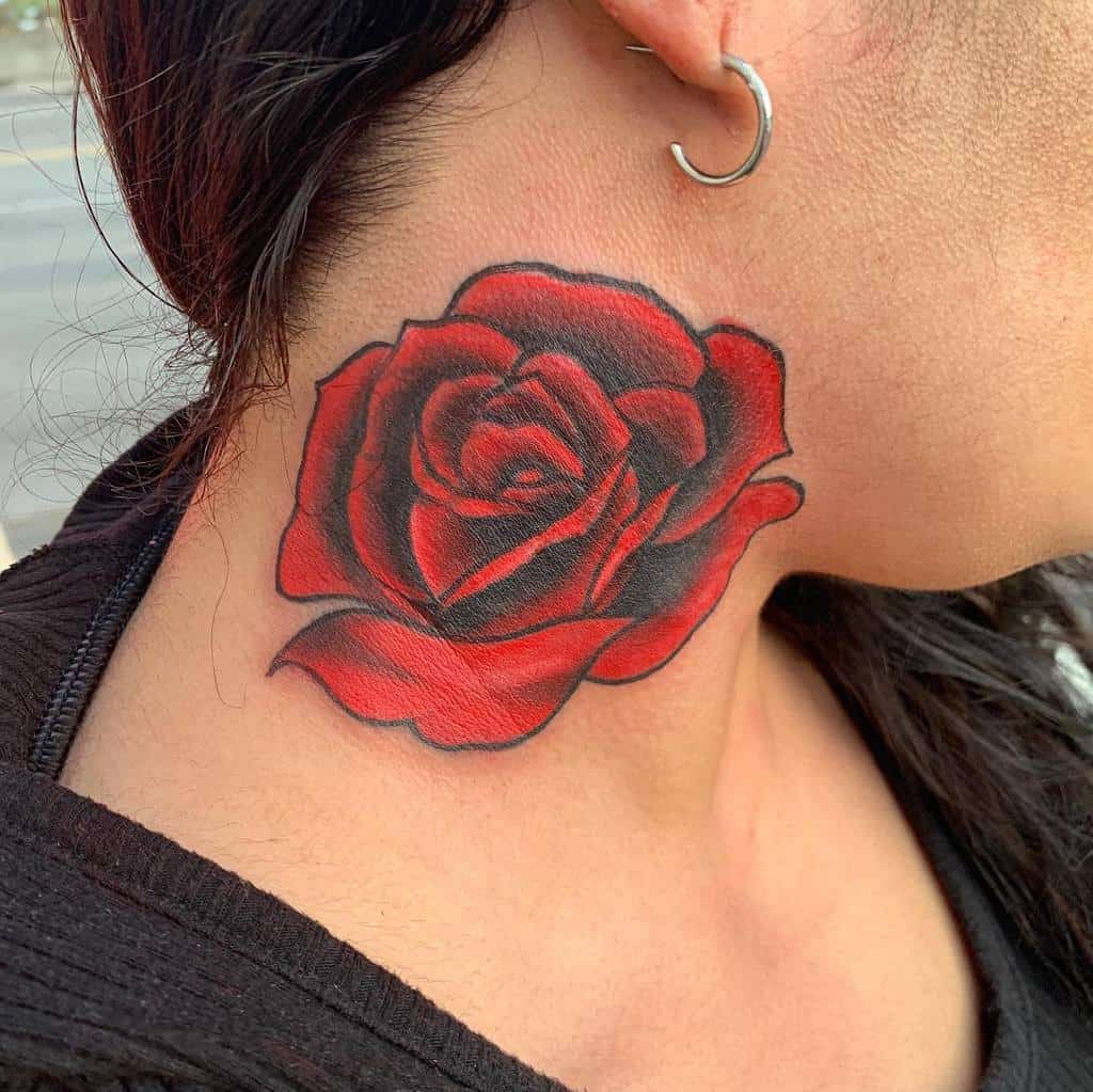A neck tattoo featuring the intricate beauty of a red rose, enhanced with striking black detailing