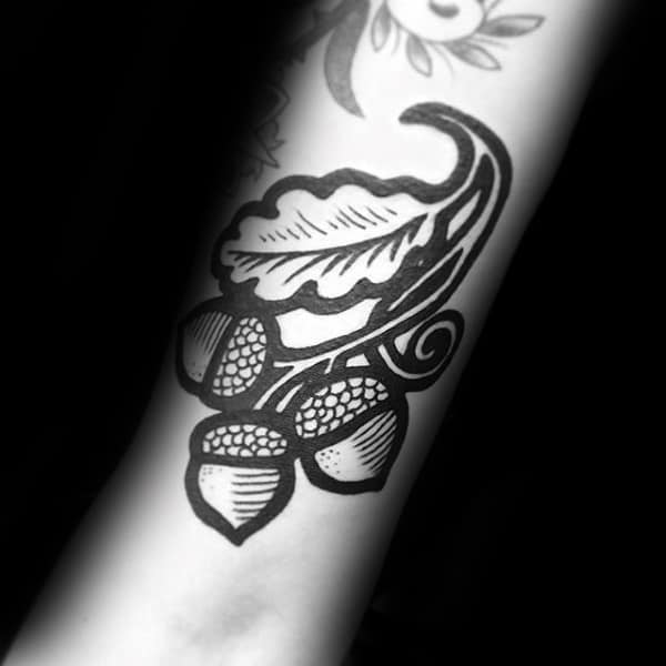 Negative Space Black Ink Male Acorn Tattoo On Forearm