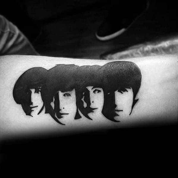 Bold black ink tattoo of The Beatles' faces in a classic shadowed stencil style, capturing their iconic early look.