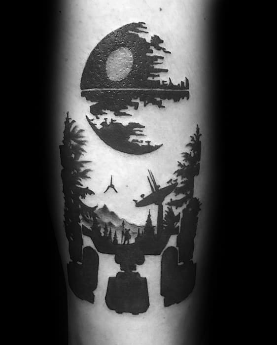 Star Wars-inspired tattoo featuring the Death Star, forest landscape, AT-AT silhouette, and fighter ship