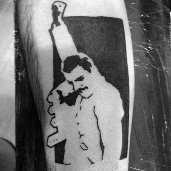 Minimalist blackwork tattoo of Freddie Mercury in his iconic fist-raised pose, using bold contrast and clean lines for a striking silhouette.