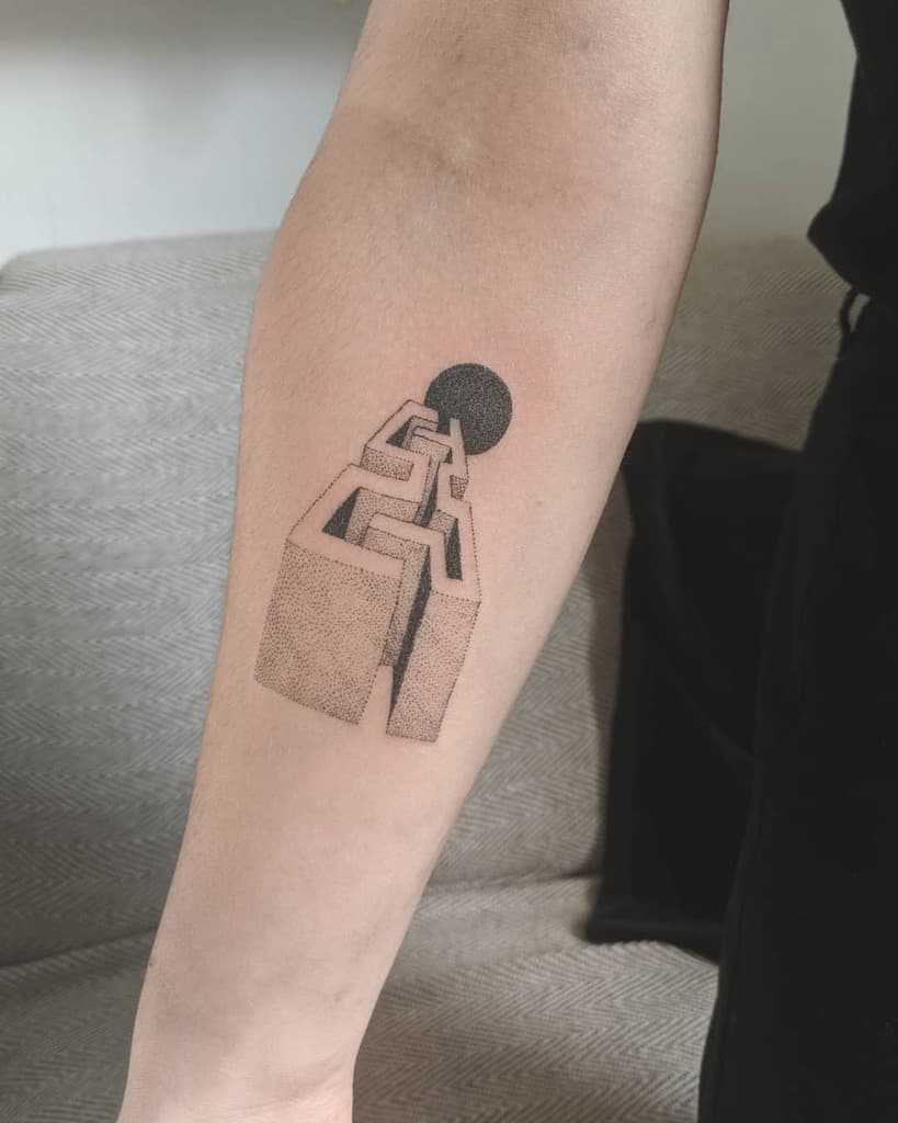 Forearm tattoo featuring an abstract geometric structure with a black sphere, using fine dot work to create depth and a surreal perspective.