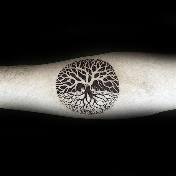 Negative Space Small Circle Tree Of Life Tattoo Design On Inner Forearm