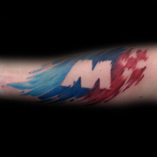 Bold BMW M logo tattoo on forearm, featuring dynamic brushstroke effects in blue and red for a powerful motorsport-inspired design.
