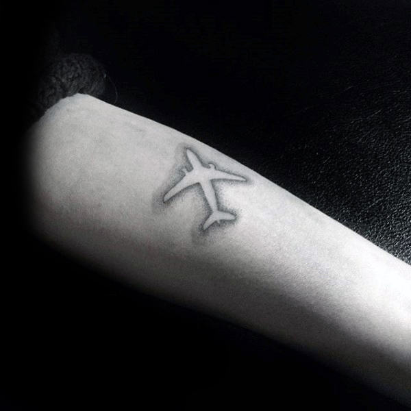 Negative Space Mens Airplane Small Travel Tattoo On Forearm