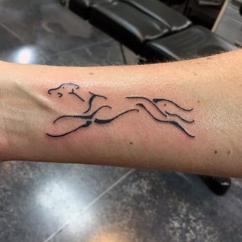 Negative Space Running Greyhound Dog Tattoo On Mans Wrist