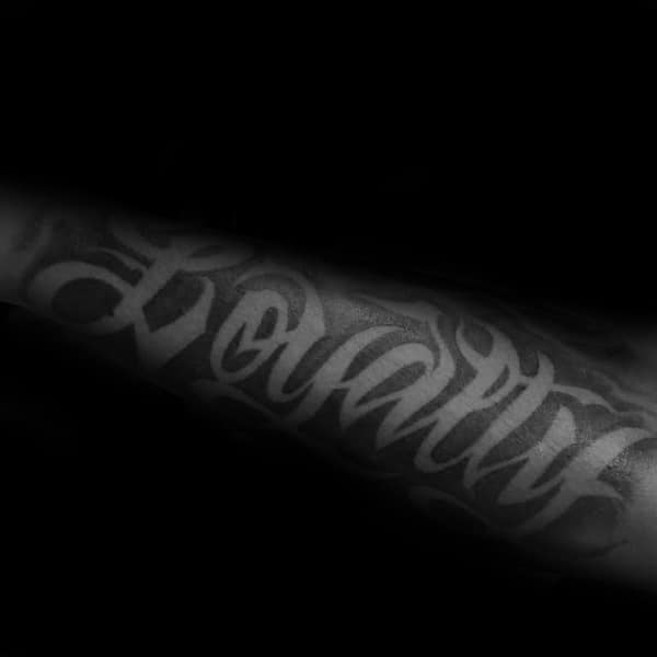 Negative Space Tattoo Of Loyalty Word On Male