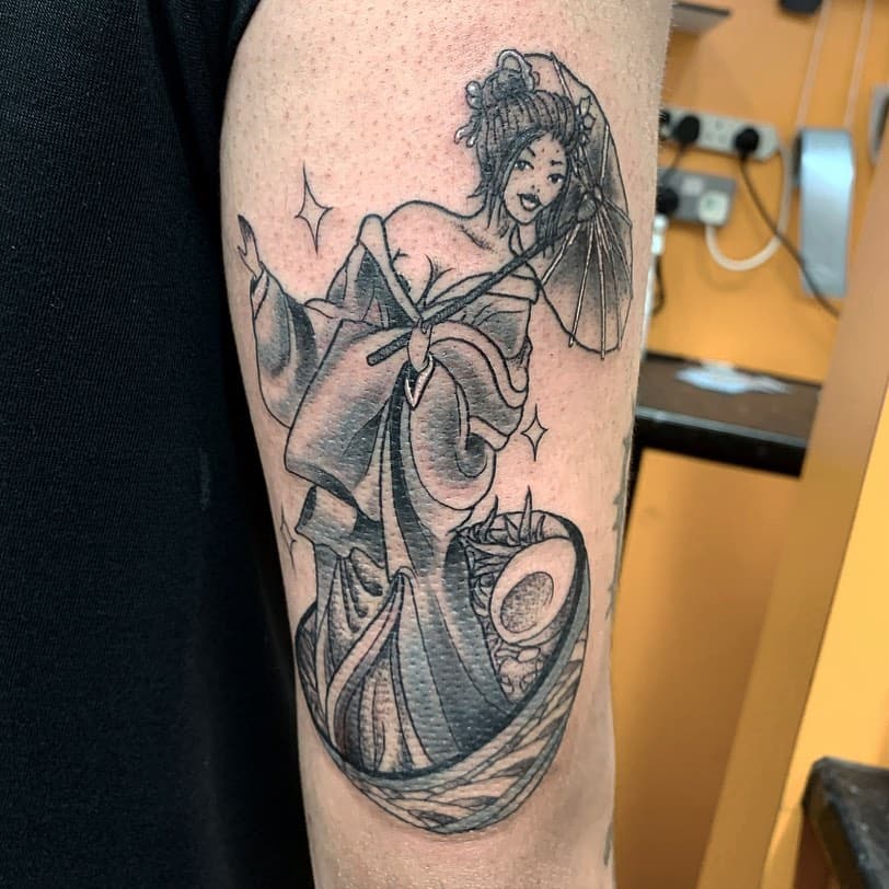 A detailed black and grey geisha tattoo with elegant linework, shading, and a graceful, flowing design.