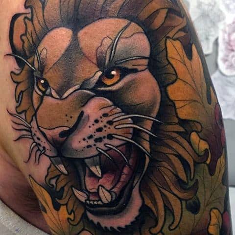 Neo-traditional roaring lion tattoo with intense amber eyes, autumn leaves, and bold shading for a fierce and seasonal design.