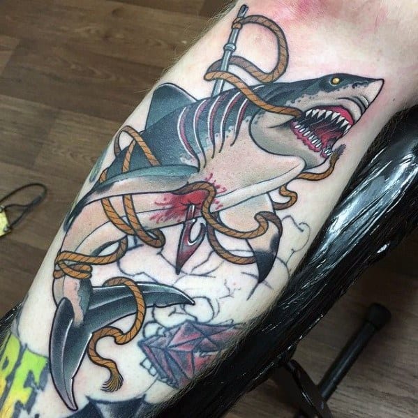 Neo-traditional shark tattoo wrapped in thick orange rope with visible wounds, dynamic pose, and detailed hook piercing the skin.