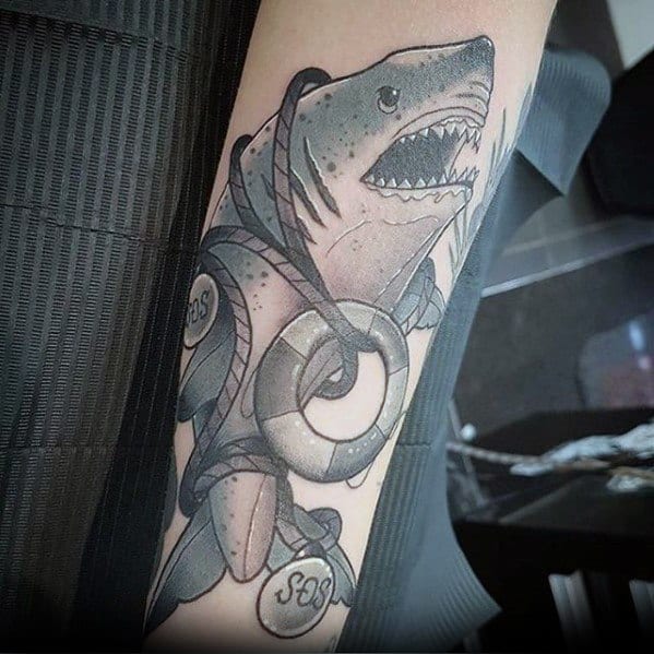 Neo-traditional shark tattoo in black and grey, wrapped in rope with SOS lifebuoys, bold shading, and a fierce expression.