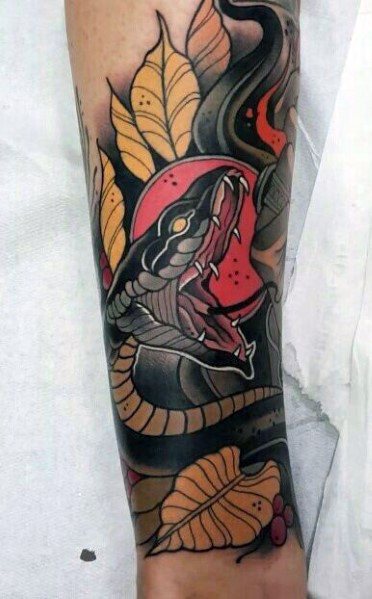 Neo-traditional tattoo of a fierce black snake with an open mouth, surrounded by autumn leaves and bold red accents for a striking, dynamic design.