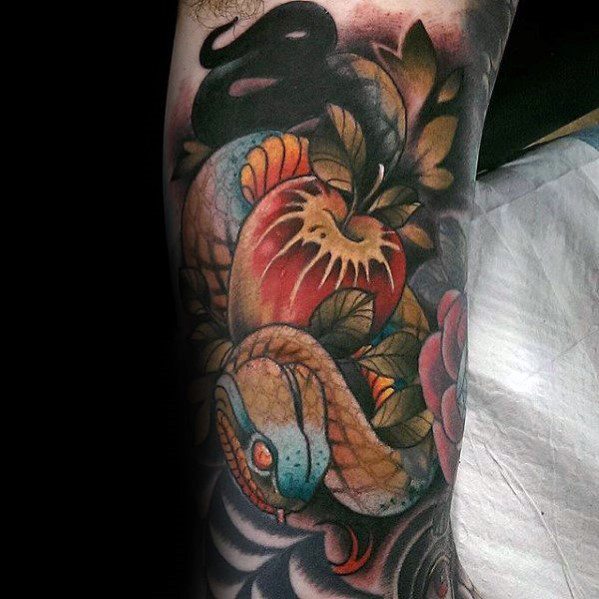 Neo-traditional tattoo of a coiled snake with blue and gold scales, surrounded by lush foliage and a heart-shaped apple with dramatic shading.