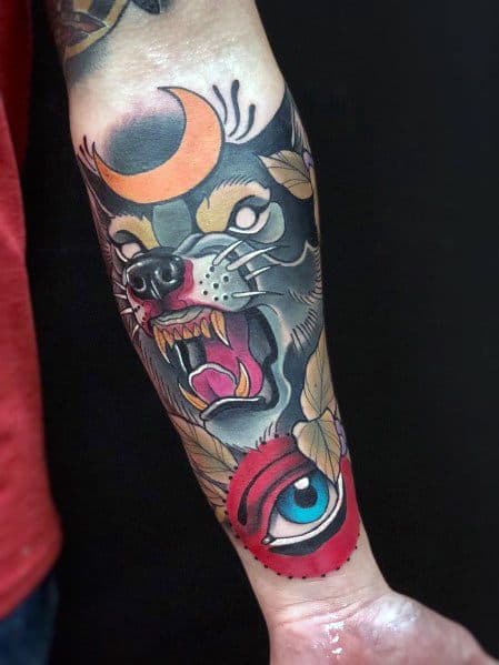 Neo-traditional wolf tattoo with a fierce expression, crescent moon on its forehead, bold colors, and a striking red eye design.
