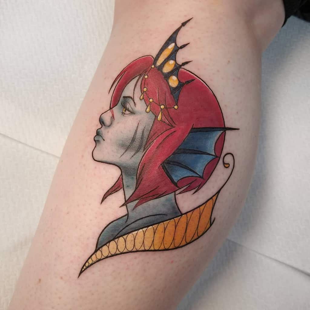 Tattoo of a fantasy siren with red hair, a crown, and dragon-like fins on neck and head