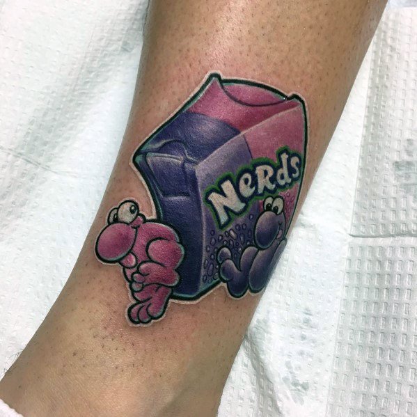 Vibrant Nerds candy tattoo featuring a detailed box with pink and purple Nerds characters playfully spilling out in a bold, cartoonish style.