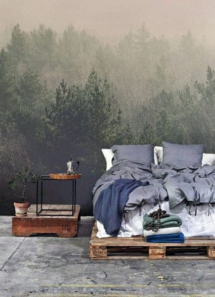 Bedroom with a forest mural, wooden pallet bed, and cozy gray bedding